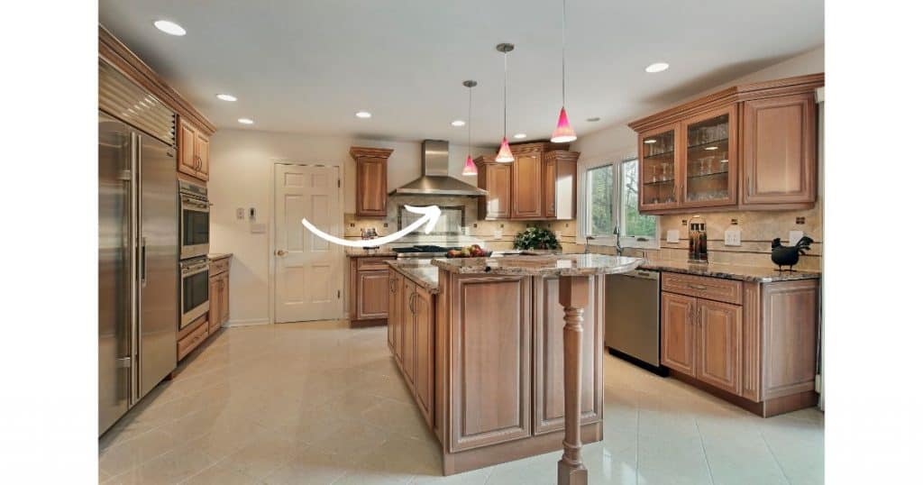 add stainless steel chimmney hood to make oak cabinetry more modern