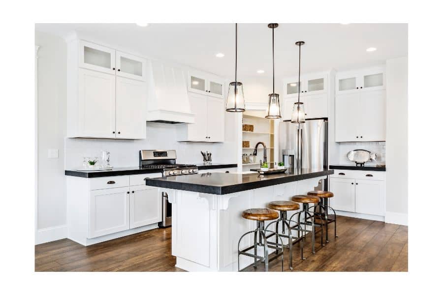 white farmhouse kitchen with black granite