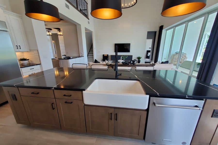 white farmhouse sink with brown cabinets
